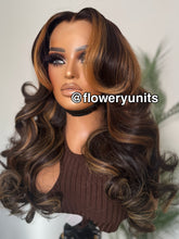 Load image into Gallery viewer, Image of a mannequin head with a glueless closure brown wig featuring honey blonde highlights. The wig is lightly layered and styled in cascading curls. The wig has curtain bangs and face framing layers.